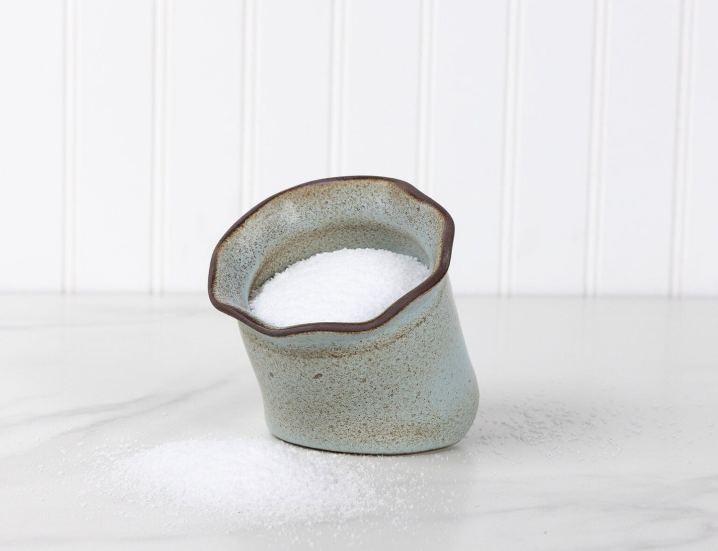 Ceramic vase with a textured surface on a white background